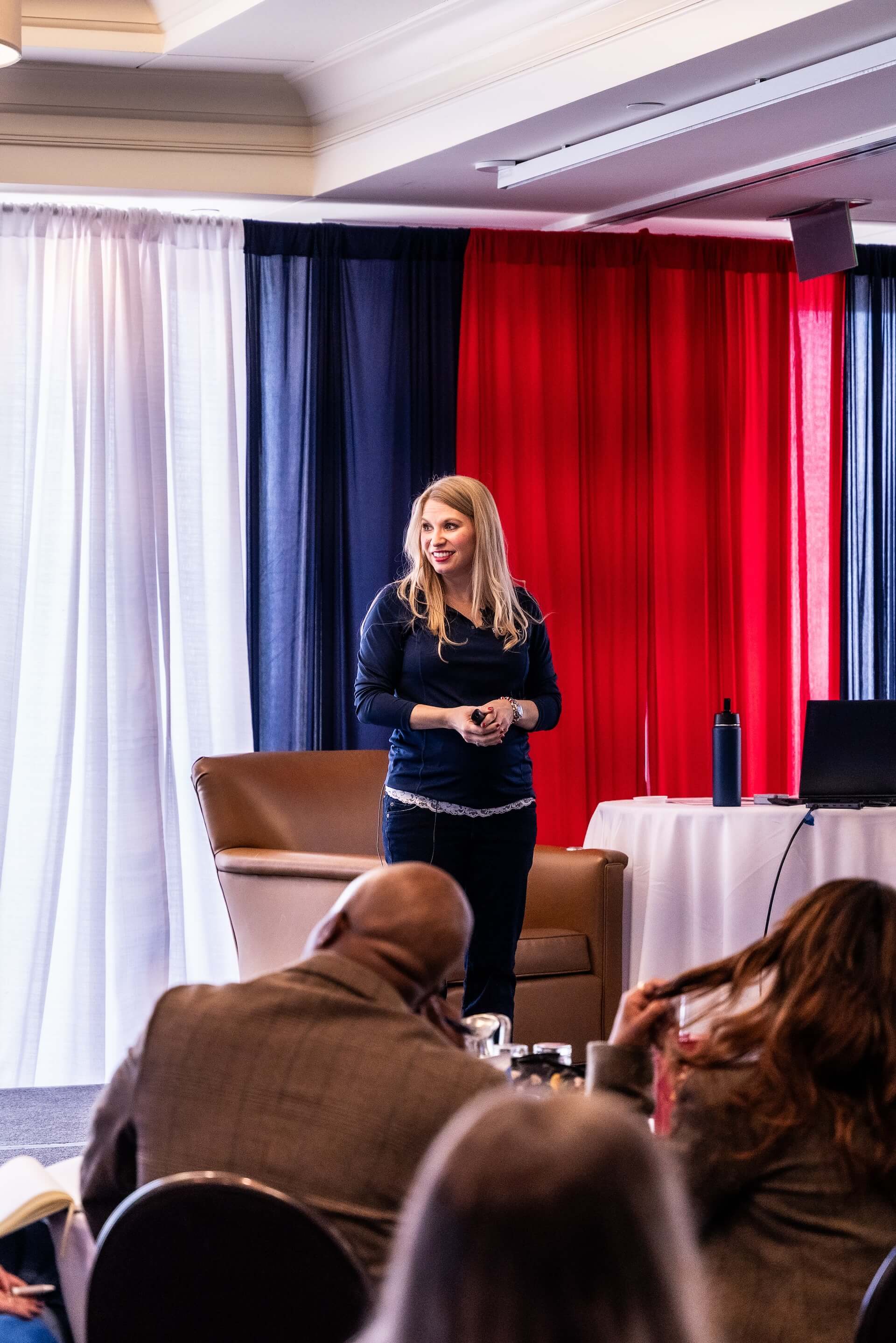 Speaker presenting on stage at a BIZROK business event