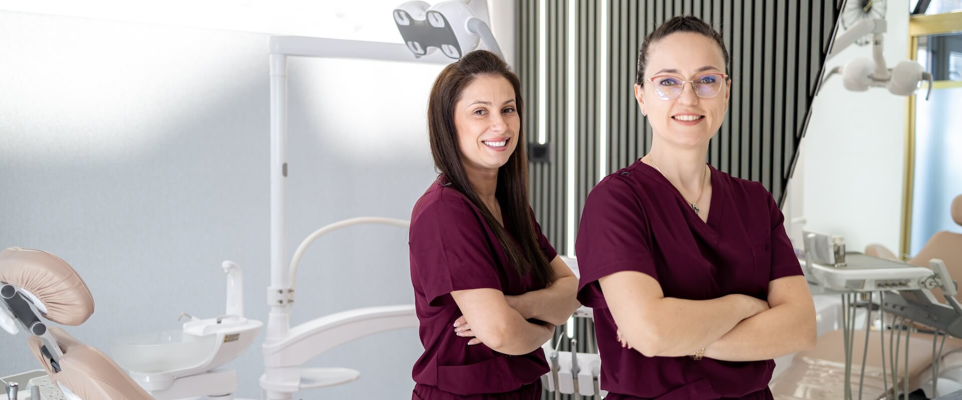Two dental professionals standing together in a treatment room
