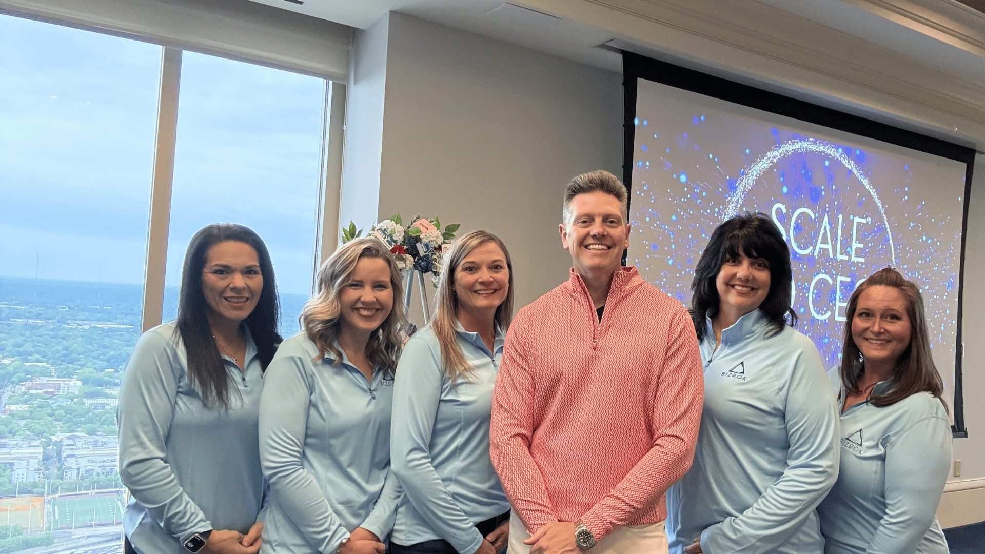 BIZROK team in branded quarter-zips at a Scale to CEO event